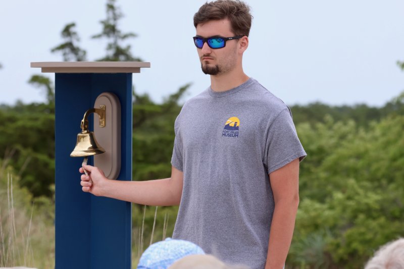 Nicholas Schimmel, grandson of the late Gary Wray, tolls the ship’s bell as the names of each of the 40 Delawareans who gave their lives in the Battle of Normandy are read aloud.